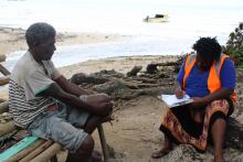 A member of the assessment team conducting assessments on the field